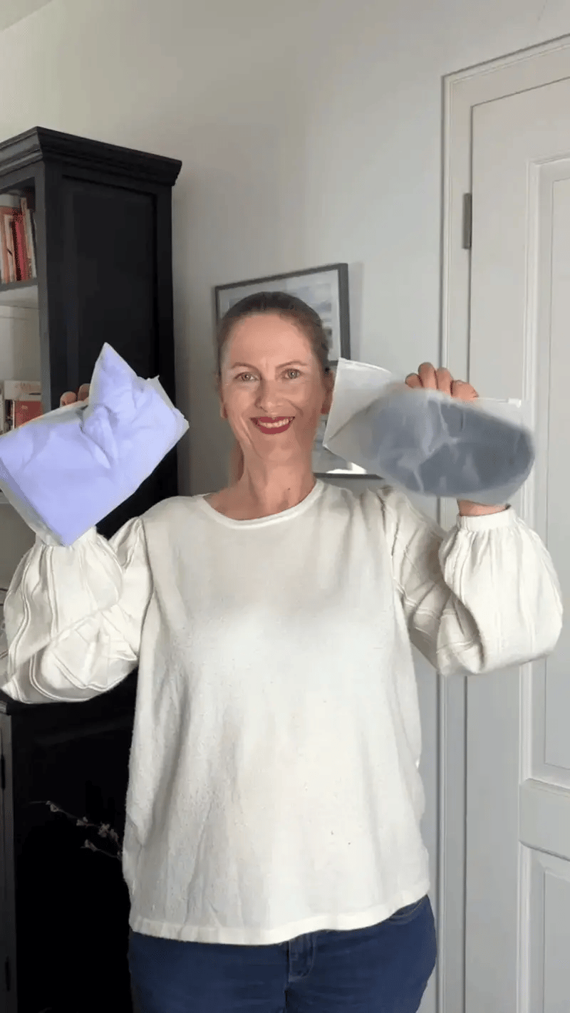 Woman holding two pairs of CelluFlex leggings